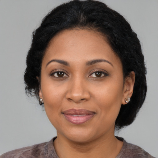 Joyful latino adult female with medium  black hair and brown eyes