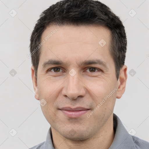 Joyful white adult male with short  black hair and brown eyes