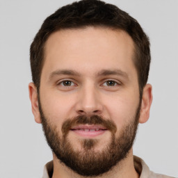 Joyful white young-adult male with short  brown hair and brown eyes