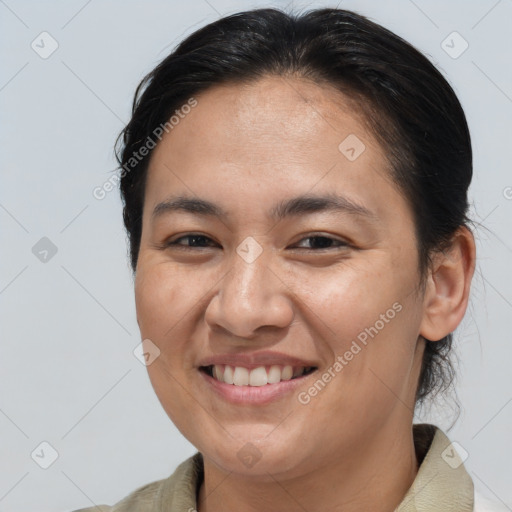 Joyful white adult female with medium  brown hair and brown eyes