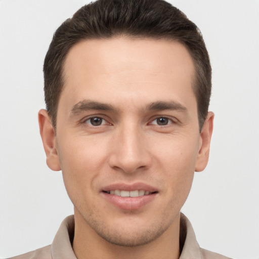 Joyful white young-adult male with short  brown hair and brown eyes