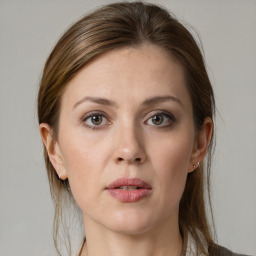 Joyful white young-adult female with medium  brown hair and grey eyes