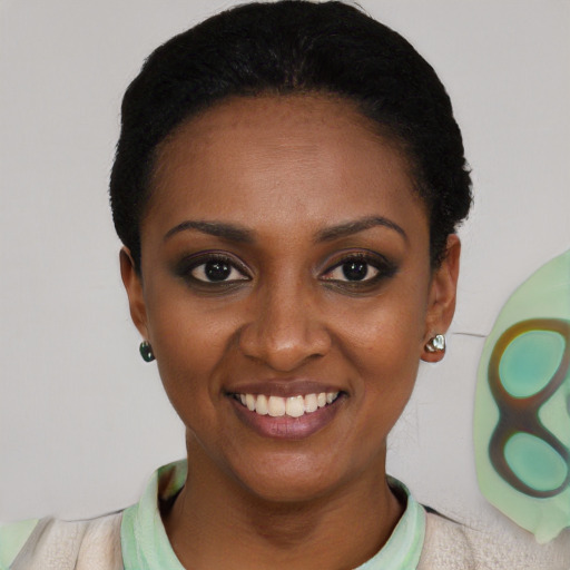 Joyful black young-adult female with short  black hair and brown eyes