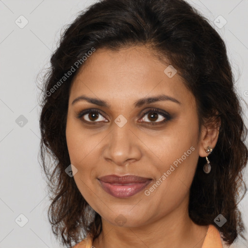 Joyful black adult female with medium  brown hair and brown eyes