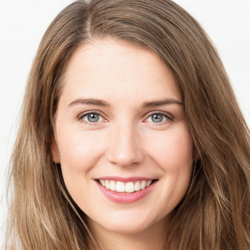 Joyful white young-adult female with long  brown hair and green eyes