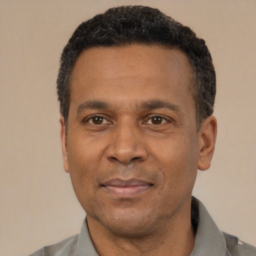 Joyful latino adult male with short  black hair and brown eyes