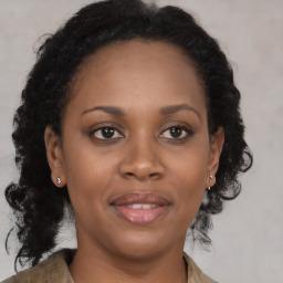 Joyful black adult female with medium  brown hair and brown eyes