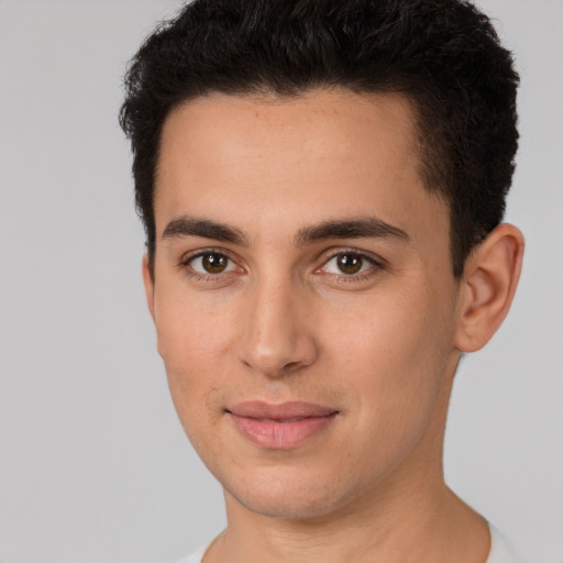 Joyful white young-adult male with short  black hair and brown eyes