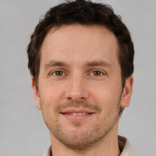 Joyful white young-adult male with short  brown hair and brown eyes