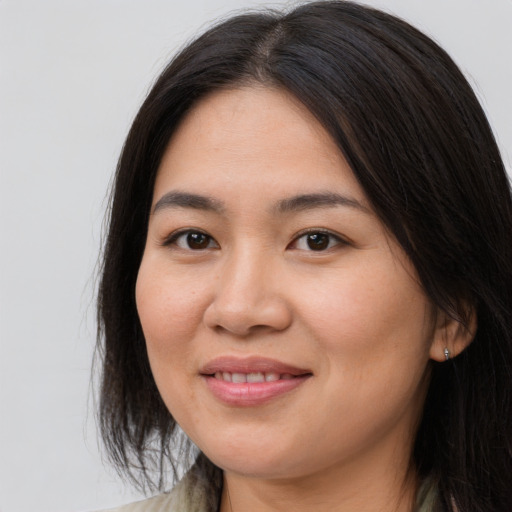 Joyful asian young-adult female with medium  brown hair and brown eyes