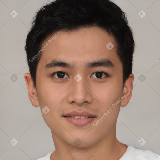 Joyful asian young-adult male with short  brown hair and brown eyes