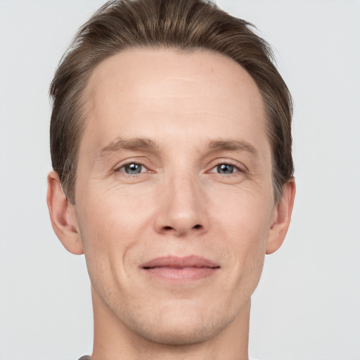 Joyful white adult male with short  brown hair and grey eyes