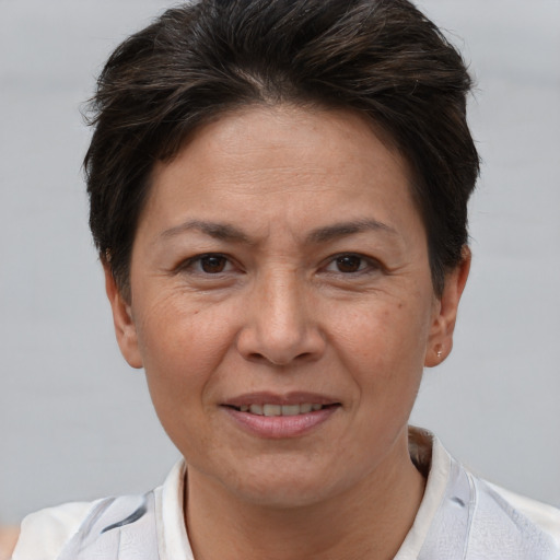 Joyful white adult female with short  brown hair and brown eyes