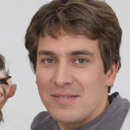 Joyful white adult male with medium  brown hair and brown eyes