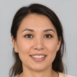 Joyful white young-adult female with medium  brown hair and brown eyes