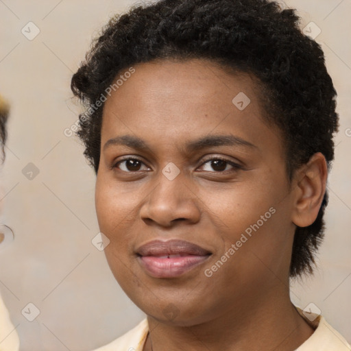 Joyful black young-adult female with short  brown hair and brown eyes