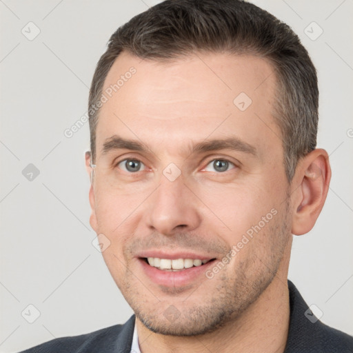 Joyful white adult male with short  brown hair and brown eyes