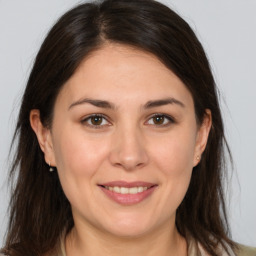 Joyful white young-adult female with medium  brown hair and brown eyes