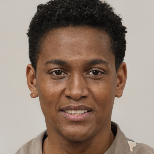 Joyful black young-adult male with short  black hair and brown eyes