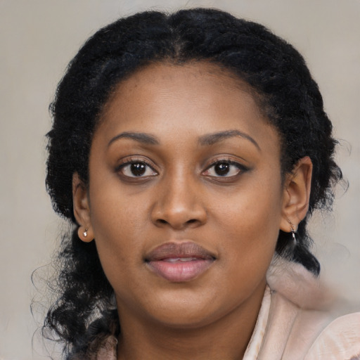 Joyful black young-adult female with medium  black hair and brown eyes