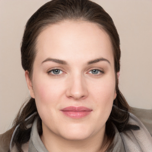 Joyful white young-adult female with long  brown hair and grey eyes