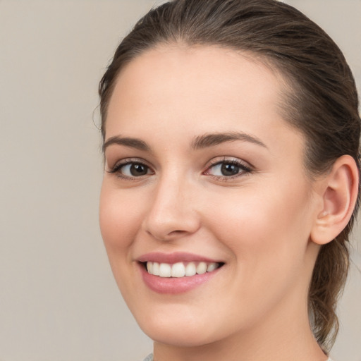 Joyful white young-adult female with medium  brown hair and brown eyes