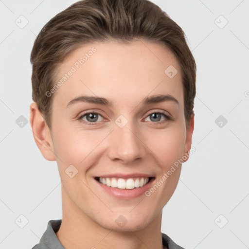 Joyful white young-adult female with short  brown hair and grey eyes