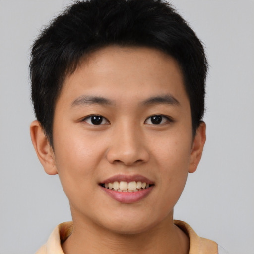 Joyful asian young-adult male with short  brown hair and brown eyes