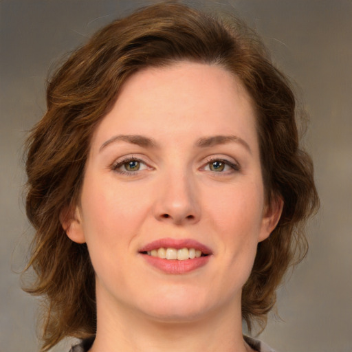 Joyful white young-adult female with medium  brown hair and green eyes