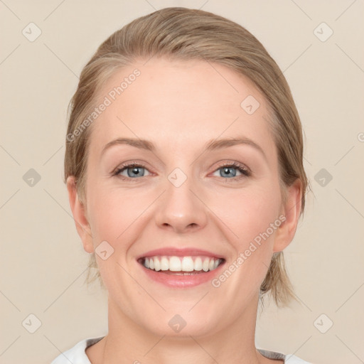 Joyful white young-adult female with medium  brown hair and blue eyes