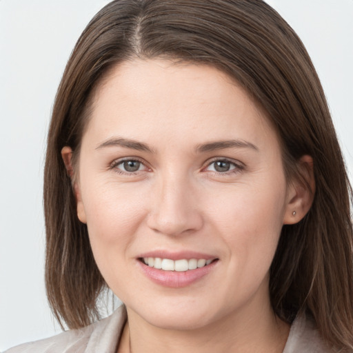 Joyful white young-adult female with long  brown hair and grey eyes