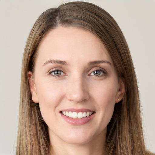 Joyful white young-adult female with long  brown hair and grey eyes