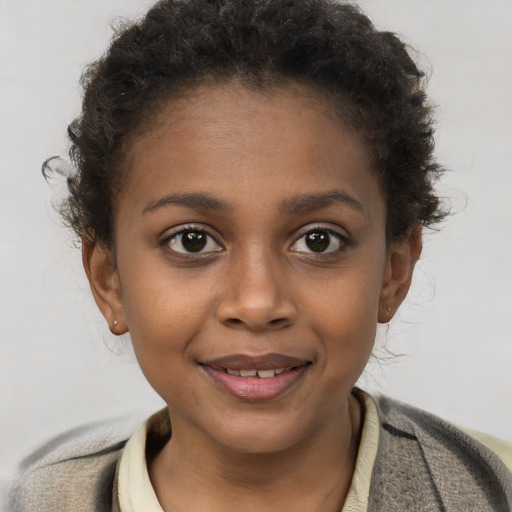 Joyful black child female with short  brown hair and brown eyes