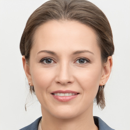 Joyful white young-adult female with medium  brown hair and grey eyes