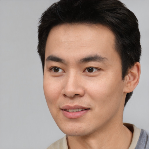 Joyful white young-adult male with short  black hair and brown eyes