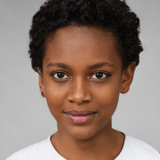 Joyful black child female with short  black hair and brown eyes