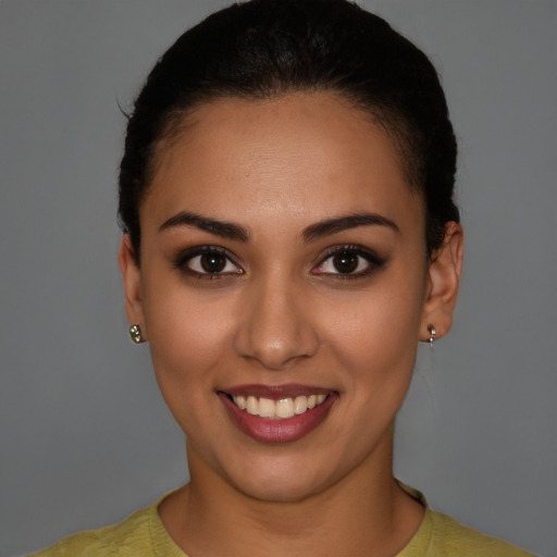 Joyful latino young-adult female with short  brown hair and brown eyes