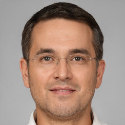 Joyful white adult male with short  brown hair and brown eyes