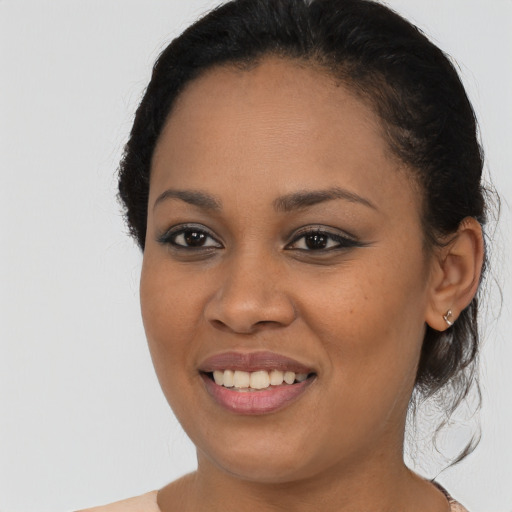 Joyful latino young-adult female with medium  black hair and brown eyes