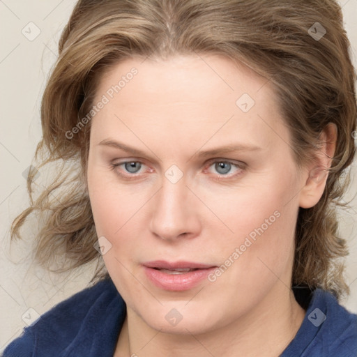 Joyful white young-adult female with medium  brown hair and blue eyes