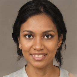 Joyful black young-adult female with medium  brown hair and brown eyes