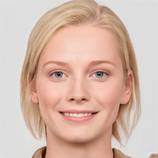 Joyful white young-adult female with medium  blond hair and blue eyes