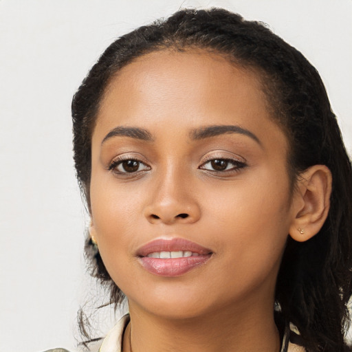 Joyful latino young-adult female with long  black hair and brown eyes