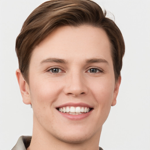 Joyful white young-adult female with short  brown hair and grey eyes