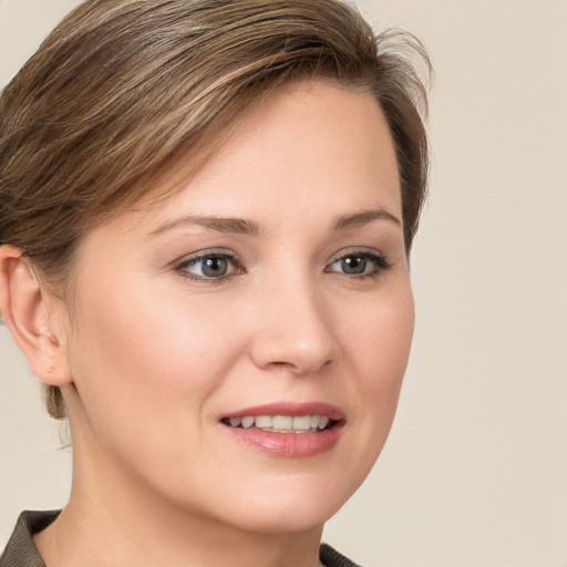 Joyful white young-adult female with medium  brown hair and grey eyes