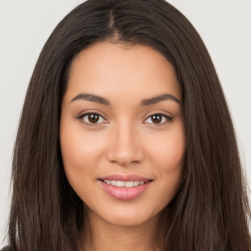 Joyful white young-adult female with long  brown hair and brown eyes