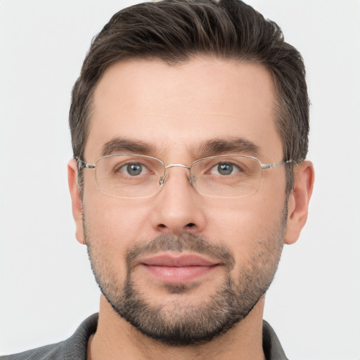 Joyful white adult male with short  brown hair and brown eyes