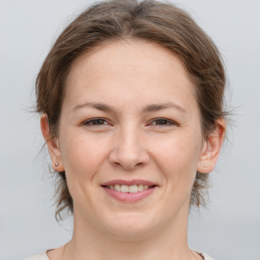 Joyful white young-adult female with medium  brown hair and brown eyes