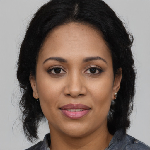 Joyful latino young-adult female with medium  black hair and brown eyes