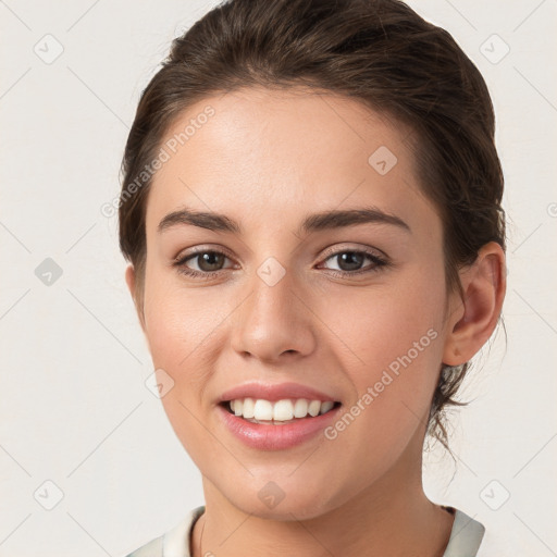 Joyful white young-adult female with medium  brown hair and grey eyes